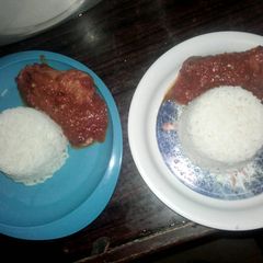 A picture of White rice with chicken stew.