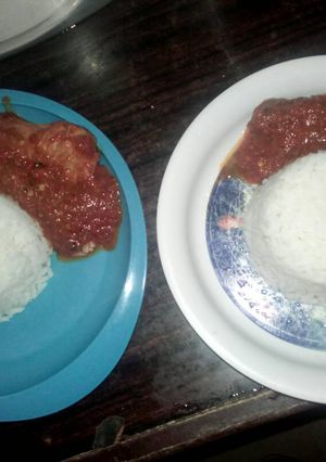 A picture of White rice with chicken stew.