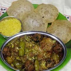 A picture of Undhiyu with puri.