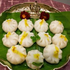A picture of Steamed Modak (Sweet coconut dumplings).