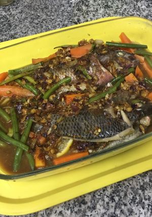 A picture of Saucey Steamed Thilapia  with Vegetables.