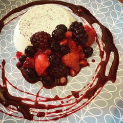 A picture of Pannacotta with Red wine poached Berries.