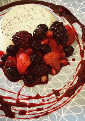 A picture of Pannacotta with Red wine poached Berries.