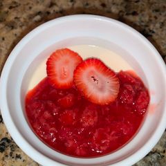 A picture of Panna Cotta with Strawberry Sauce.