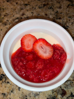 A picture of Panna Cotta with Strawberry Sauce.