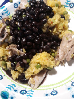 A picture of Black Beans Yellow Rice and Chicken.