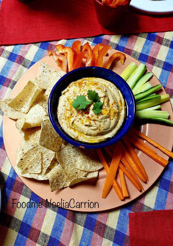 Una foto de Hummus tradicional con crudités y nachos