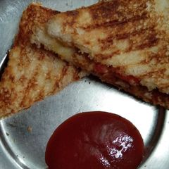 A picture of Grilled sandwich with leftover potato vegetable.