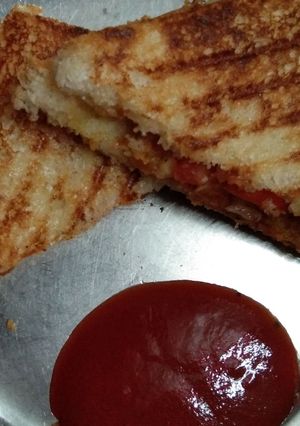 A picture of Grilled sandwich with leftover potato vegetable.