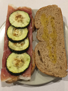 Una foto de Bocadillo de calabacín, jamón serrano, tomate triturado y orégano