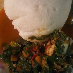 A picture of Tuwon shinkafa wif vegetable soup spinach.