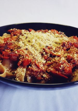 A picture of Pasta with tomato sauce and vegan parmesan.