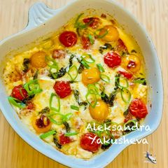 A picture of Cheese appetizer with tomatoes and sausage.