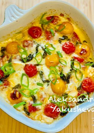 A picture of Cheese appetizer with tomatoes and sausage.