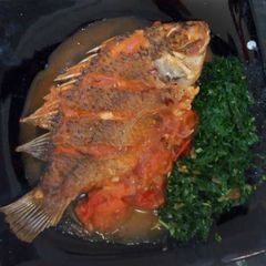 A picture of Wet fried Tilapia with steamed kales.