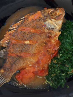 A picture of Wet fried Tilapia with steamed kales.