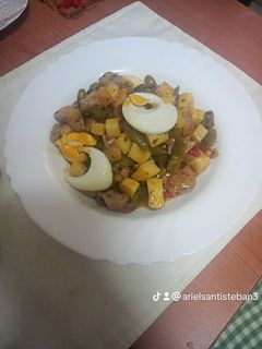 Una foto de Habichuelas compuestas con carne de cochino, papas fritas y huevo duro