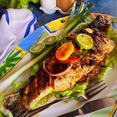 Tomato herbs shrimp stuffed grilled bhetki with lemon butter sauce A picture of Tomato herbs shrimp stuffed grilled bhetki with lemon butter sauce.