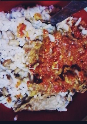 A picture of Rice and beans with stew.