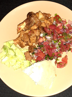 A picture of Fried pork/ugali/kachumbari/avocado.