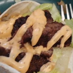 A picture of Open Steak in a wrap with lettuce & burger sauce gluten free.