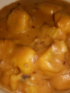 A picture of Green bananas (matoke) and peanut butter sauce.