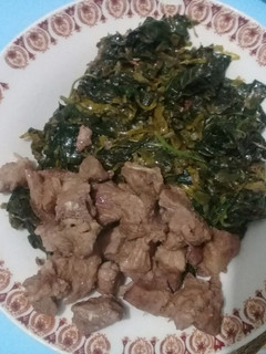 A picture of Fried mutton served with greens.