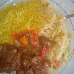 A picture of Tumeric Rice served with fried beef and steamed cabbages.