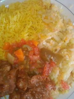 A picture of Tumeric Rice served with fried beef and steamed cabbages.