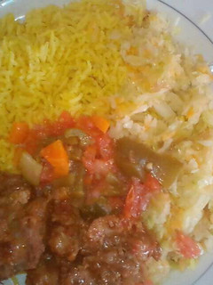 A picture of Tumeric Rice served with fried beef and steamed cabbages.