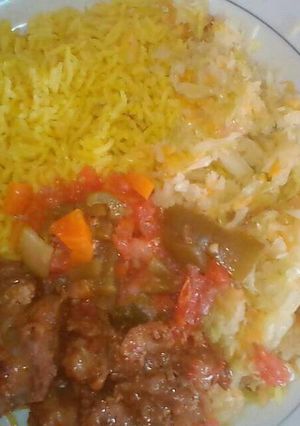 A picture of Tumeric Rice served with fried beef and steamed cabbages.