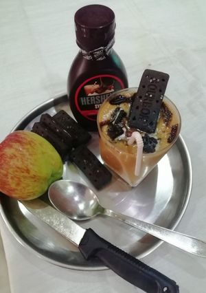 A picture of Apple milk shake with biscuit topping.