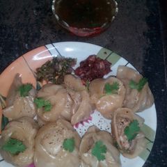 A picture of North eastern hot momos with tangy chutney.