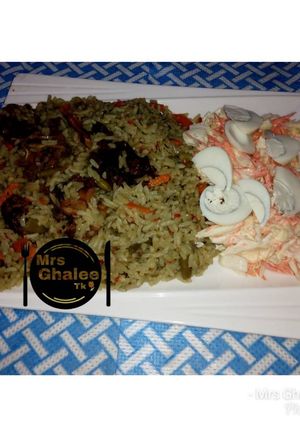 A picture of Jallof rice with coleslow.