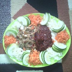 A picture of Rice and stew wit veggies.