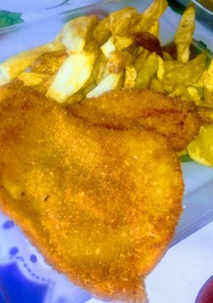 Una foto de Milanesas con fritas al disco