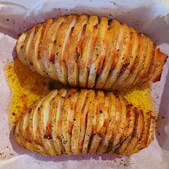 A picture of Hasselback potatoes with bacon.