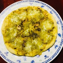 A picture of Pizza Verda! Basil and Mozzarella.
