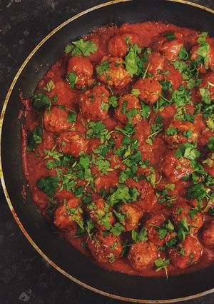 A picture of Lamb Meatballs in rich tomato sauce.