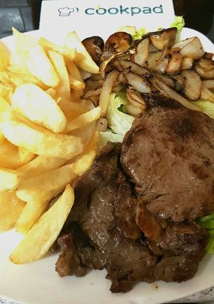A picture of Ribeye Steak onions and mushrooms. With homemade Chips 😀.