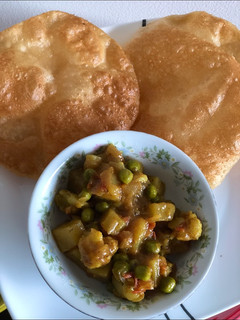 A picture of Aloo Gobhi Peas masala for poori, chapati/naan.