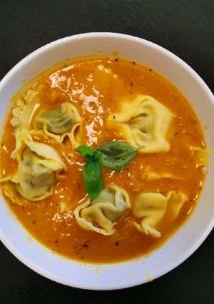 A picture of Pumpkin Soup w/spinach ricotta tortellini.