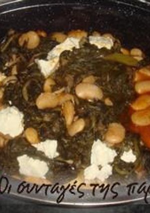 A picture of Giant beans in the oven with spinach.