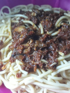 A picture of Spagetti with tomato sauce.