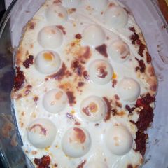 A picture of Eggs with cheese spread.