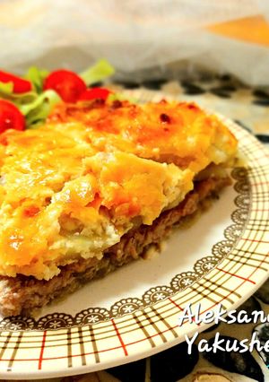 A picture of Pork chops with potatoes in the oven.