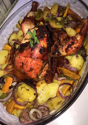A picture of Grilled chicken with potatoes and carrots.