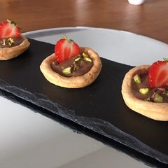A picture of Strawberry and pistachio pastries.