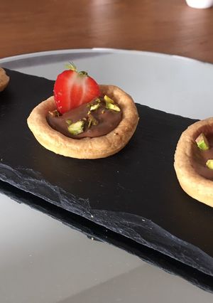 A picture of Strawberry and pistachio pastries.