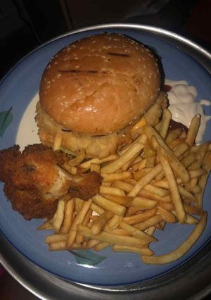 A picture of Potato chips with chicken and burger.